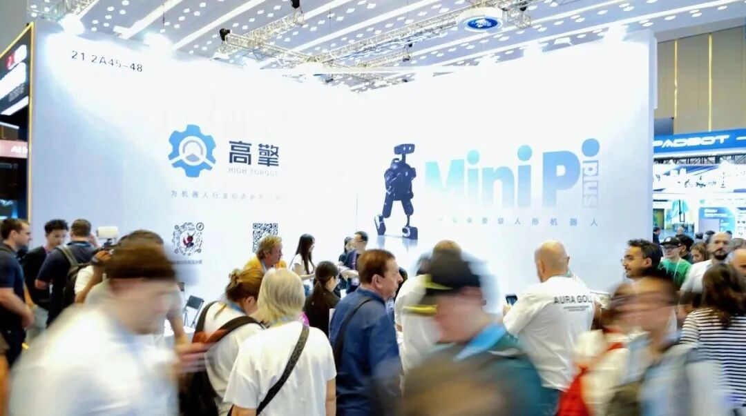 Xiao Pai interacting with visitors at the booth